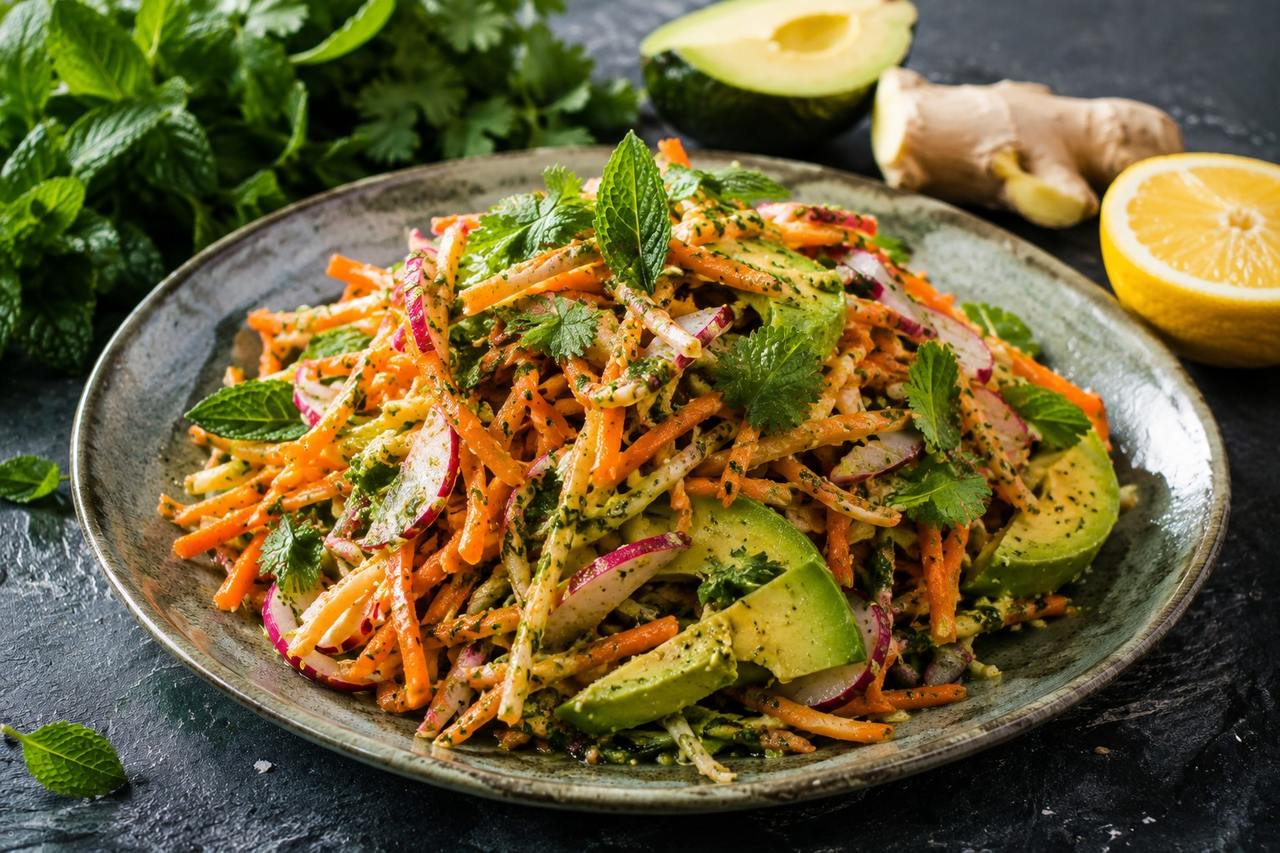 A bright raw slaw of shredded carrot and radish tossed in a no-cook mint and turmeric pesto