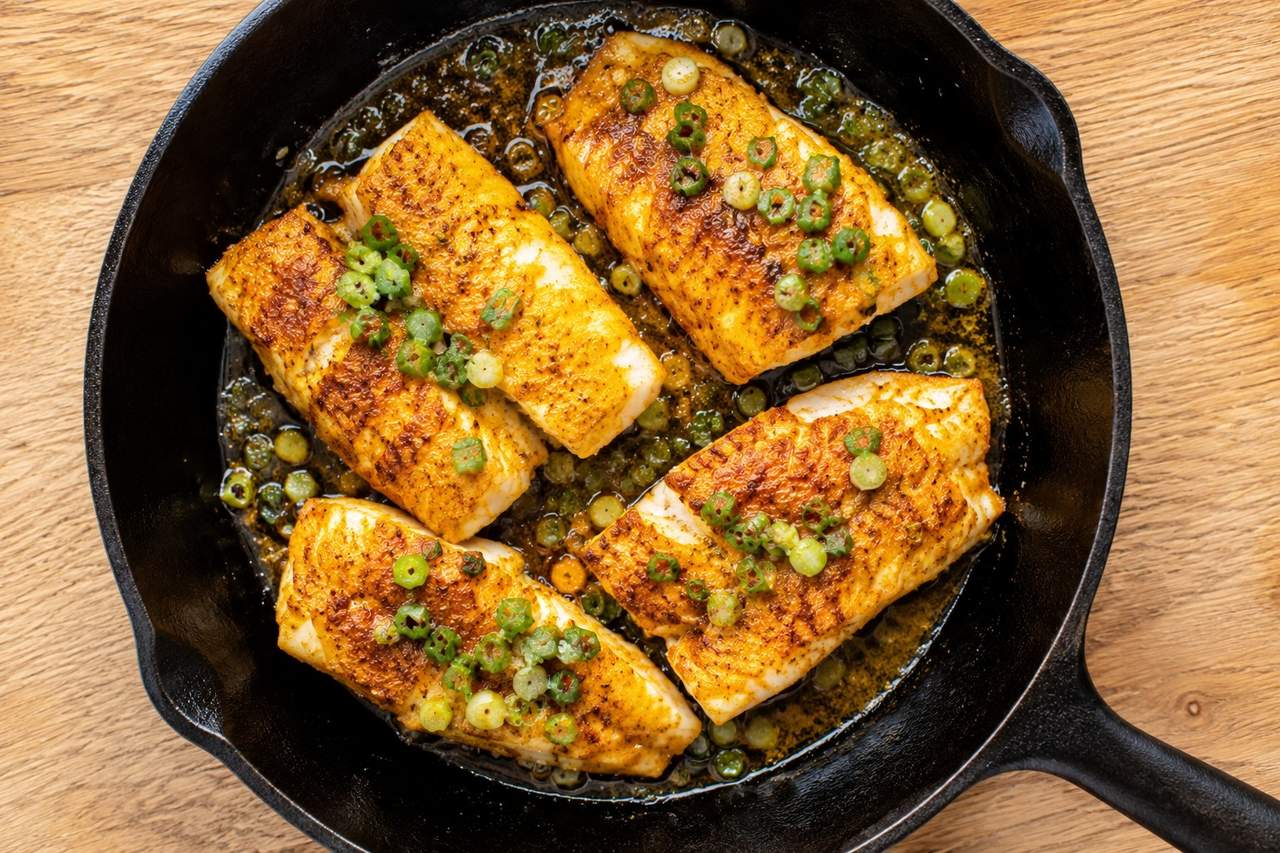 pan-cooked cod with a ginger and turmeric rub, finished with green onion, apple cider vinegar, and a touch of honey